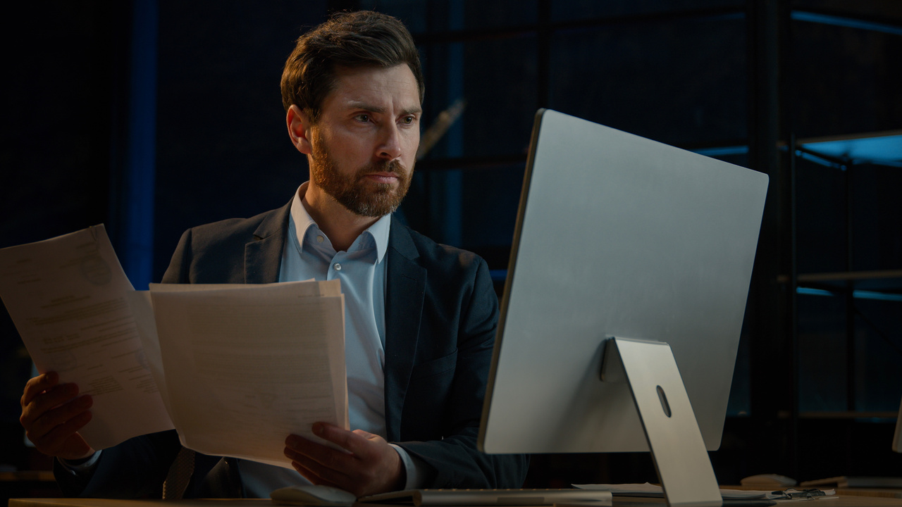 a man concentrated at work dealing with files and computer