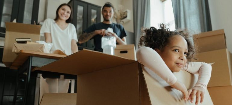 girl playing in a moving box