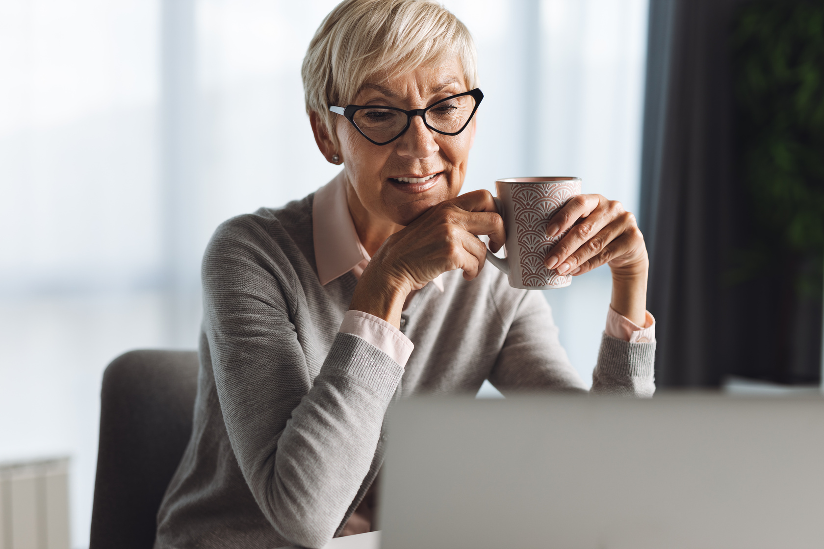 Old Women Having Coffee While Surfing Internet.
