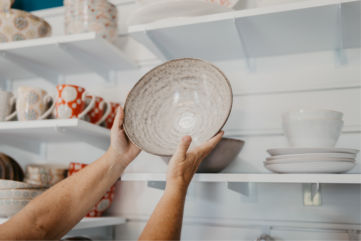 Hands hold ceramic bowl at Kitchen Collection.