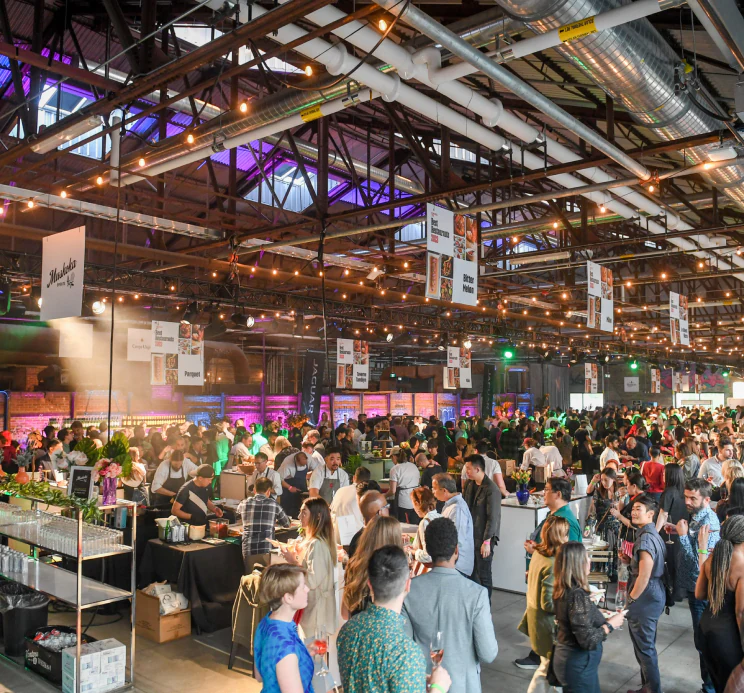 A crowd of people walking around at an event