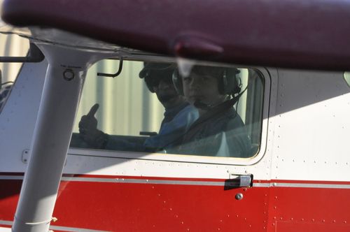Photo of Luke Arthur in the cockpit of a small Cessna airplane on his first flight lesson.