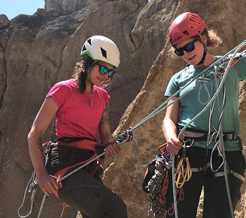 Climber demonstrating top rope climbing skills and gear as part of the AMGA program and SPI exam