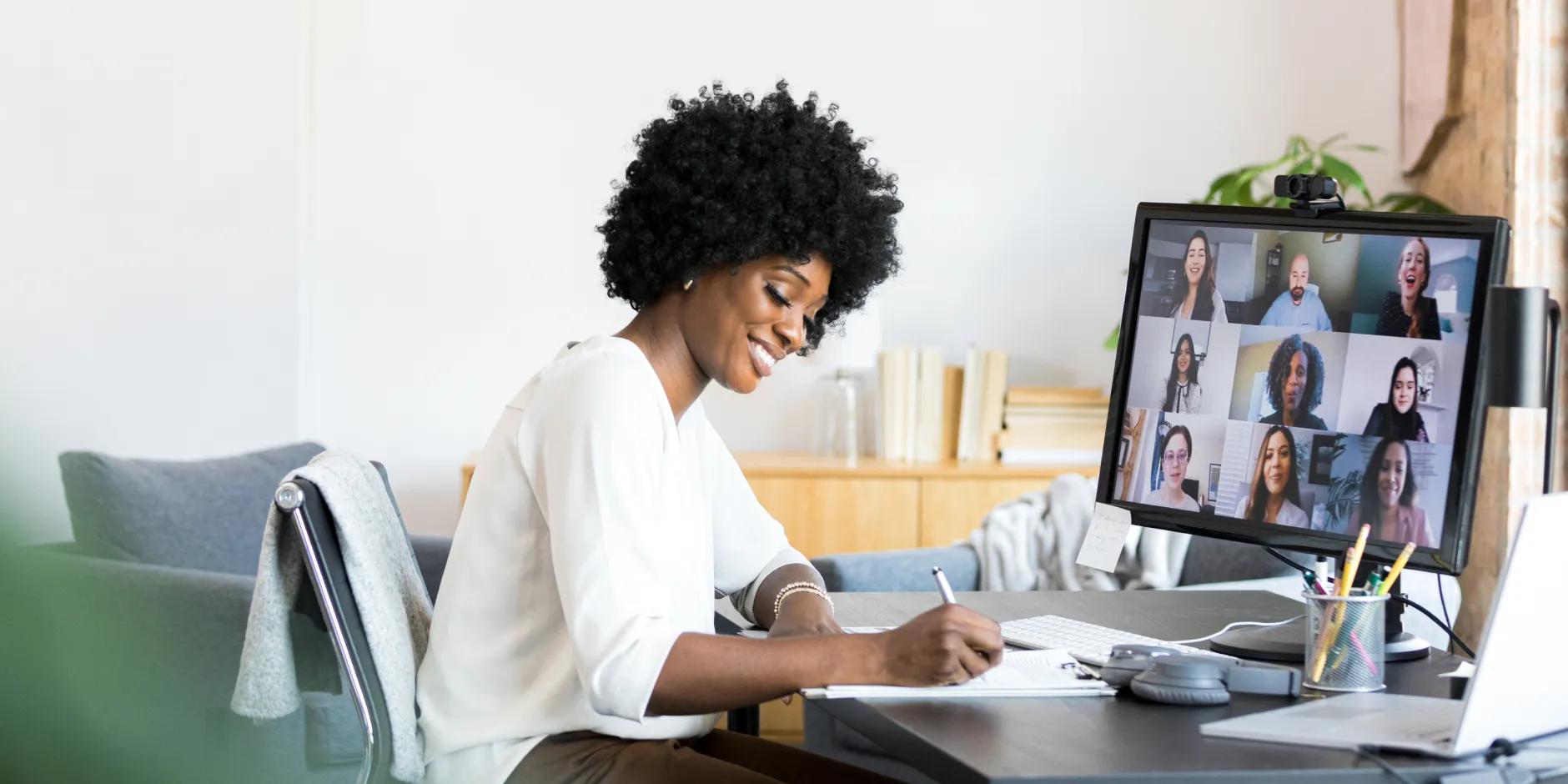 Lookout employee taking notes while in a video meeting