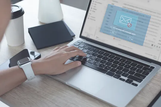 Close up of a person typing on a laptop