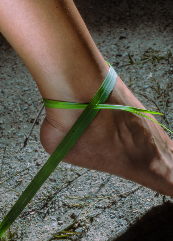 Straw of grass wrapped around ankle