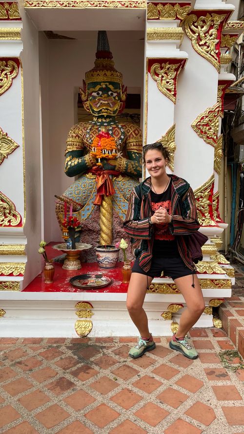 Posing beside a statue