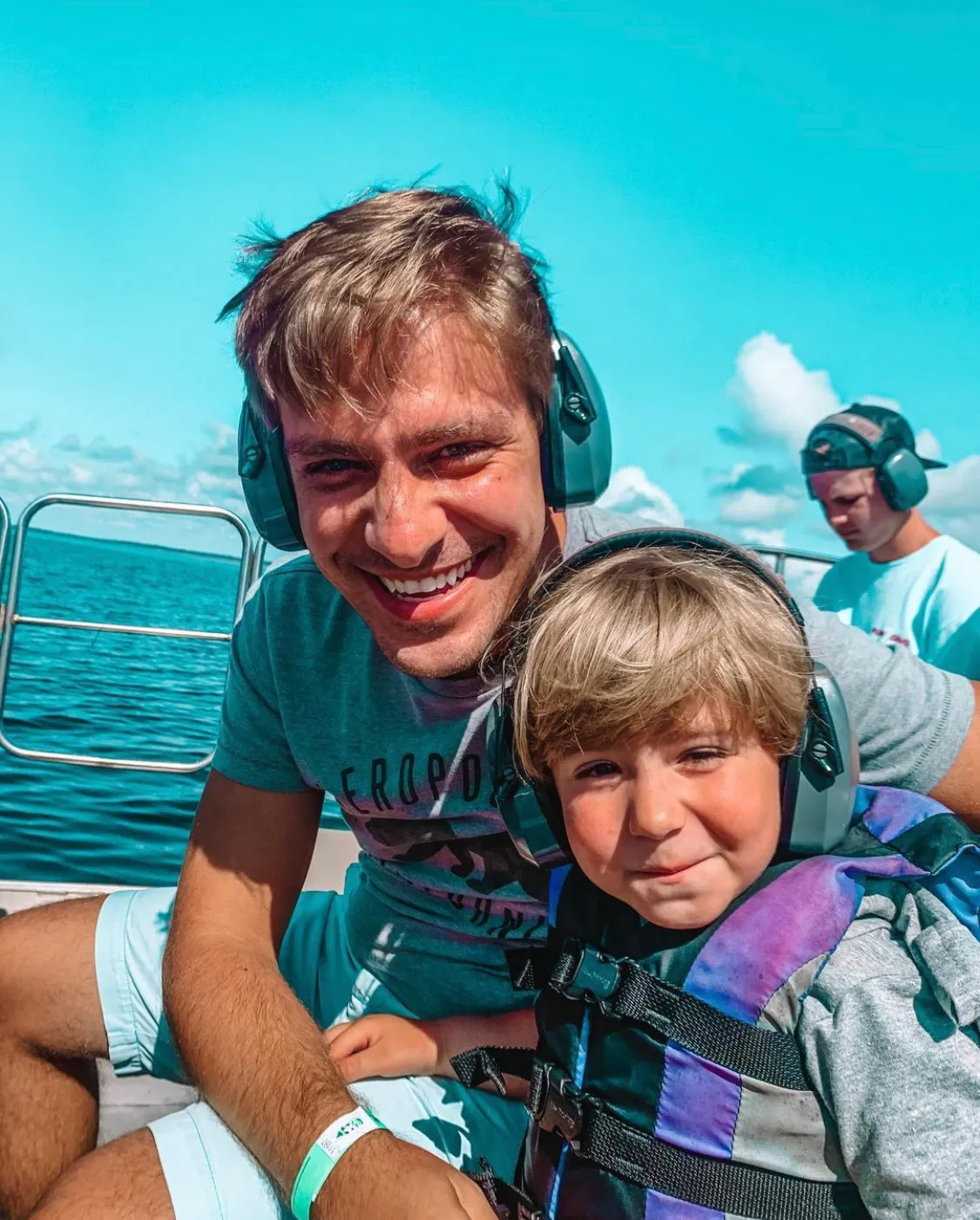A father and son enjoy a sunny day on an airboat tour at Wild Florida