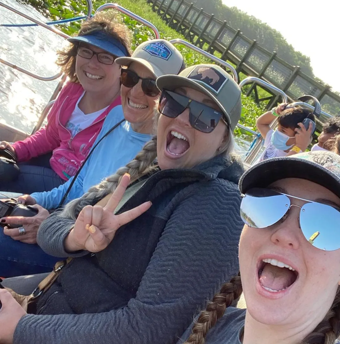 A group of women take a selfie on an airboat tour while enjoying the Everglades at Wild Florida