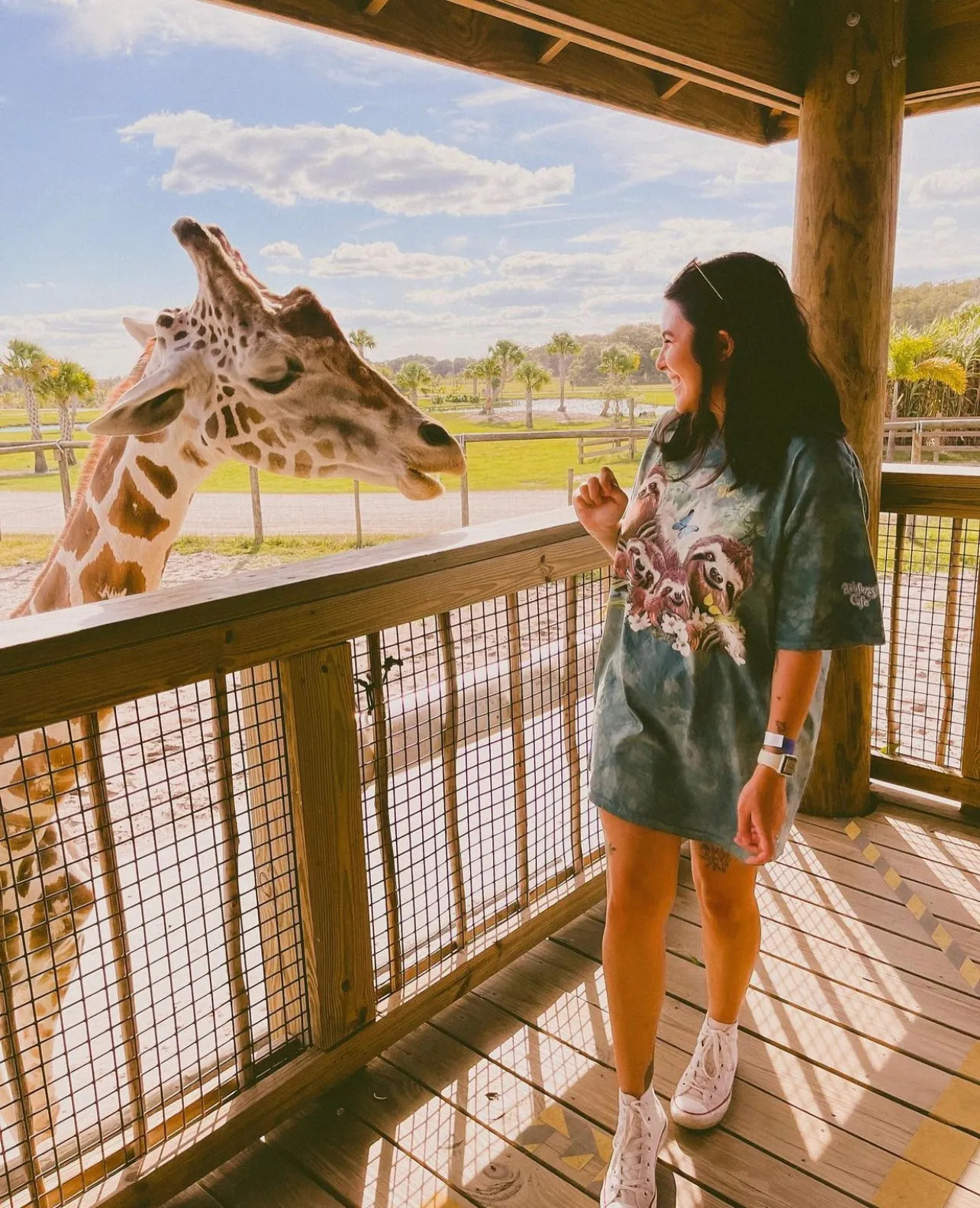 A woman interacts with a giraffe at Wild Florida