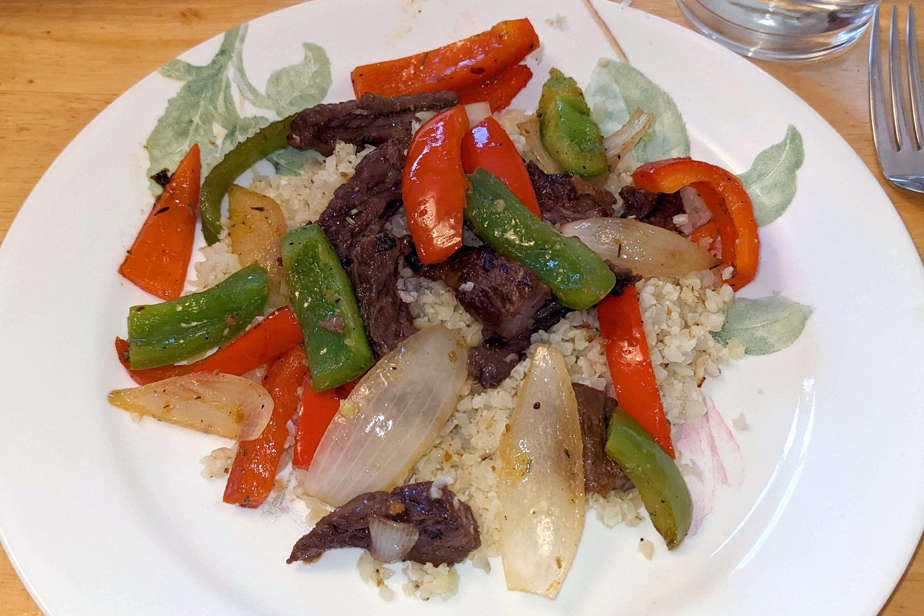 Sautéed Steak, Bell Peppers, and Onions on CauliRice Recipes NT