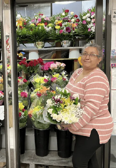 Zoila small business owner holding bunch of flowers