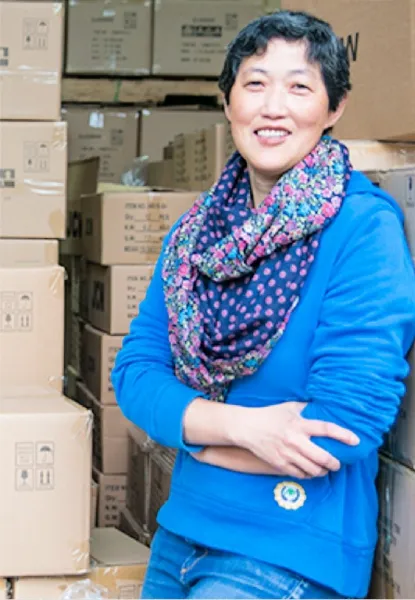 Chinese female export company owner standing and smiling