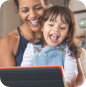 Happy mother and daughters looking at tablet