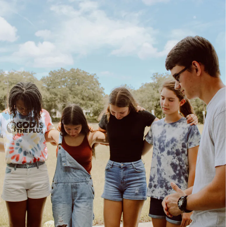 Young people praying together