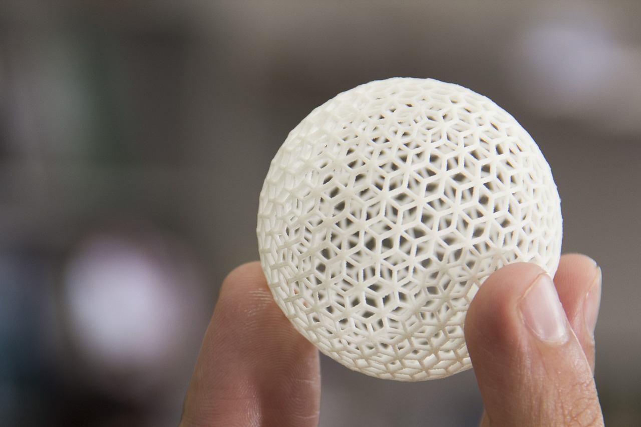 Hand holding up a highly detailed 3d printed geodesic sphere