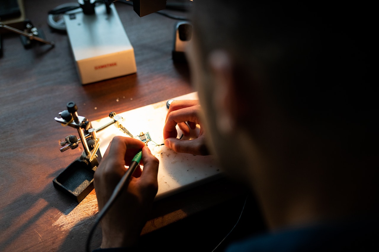 Closeup of electrical engineer's hands soldering components