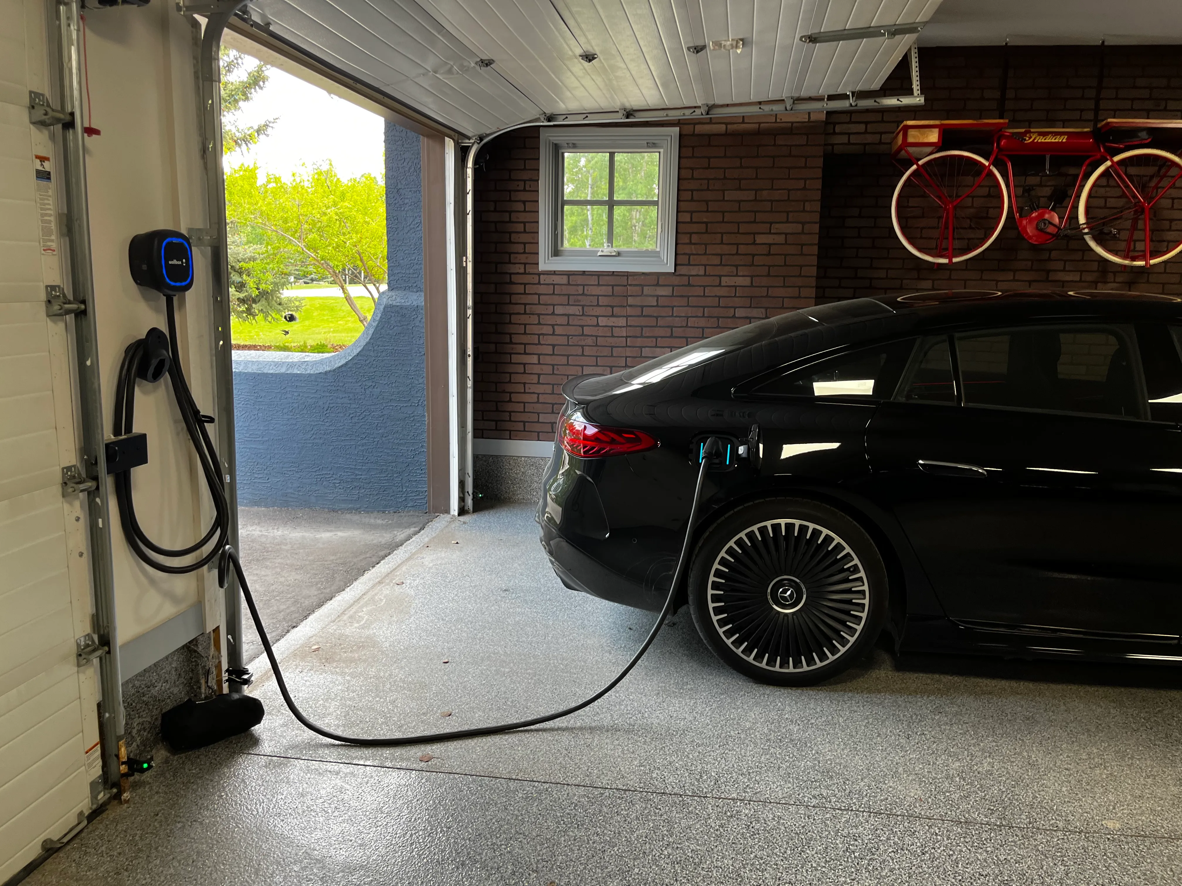 Mercedes EQS AMG charging in a garage using a wallbox pulsar plus ev-charger. 