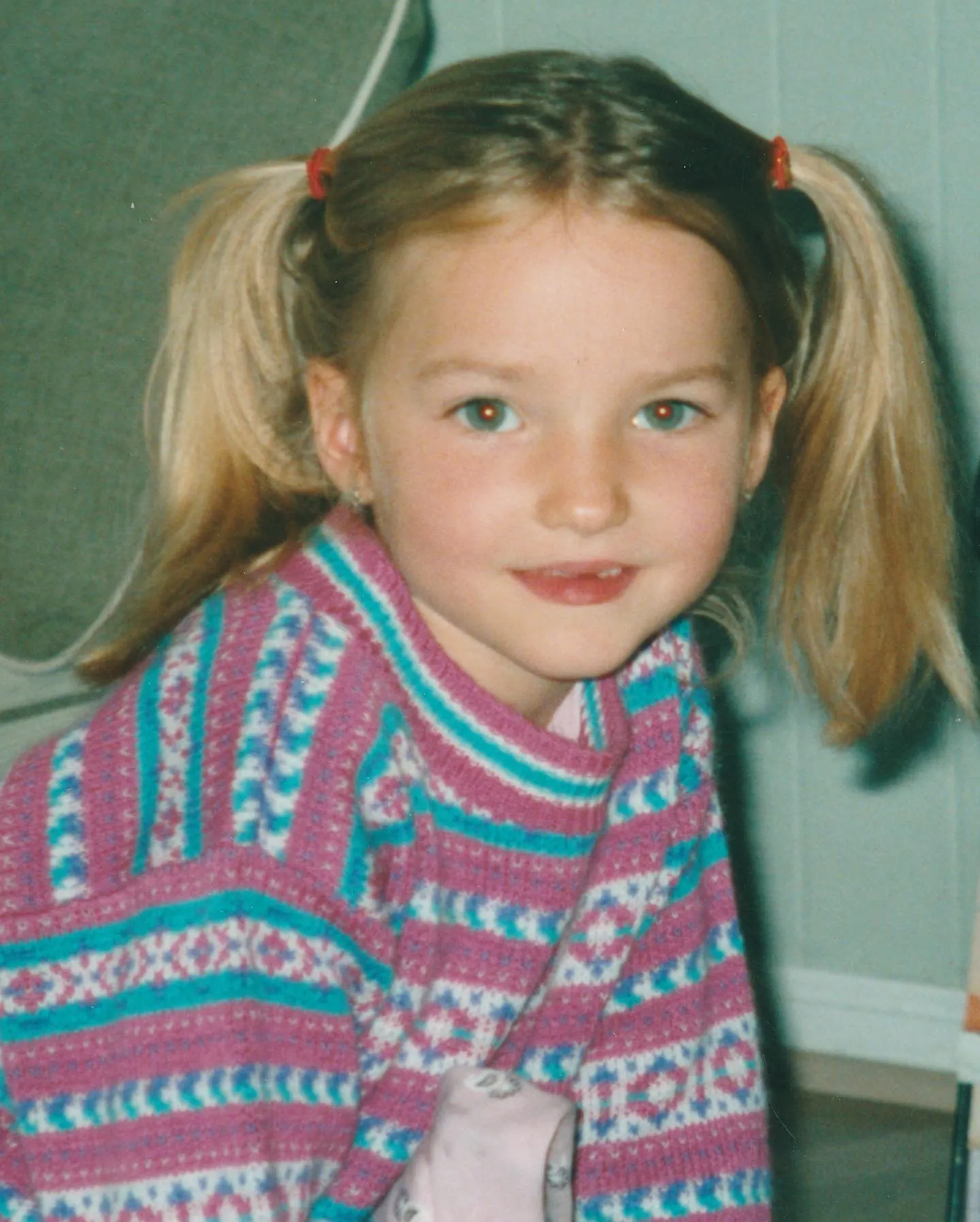 Baby Dove Cameron with two ponytails.