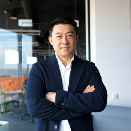 A man with his arms crossed posing for a picture.