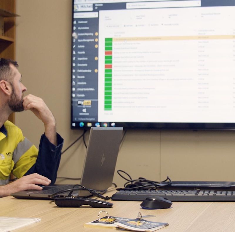 a man sitting at a desk in front of a computer