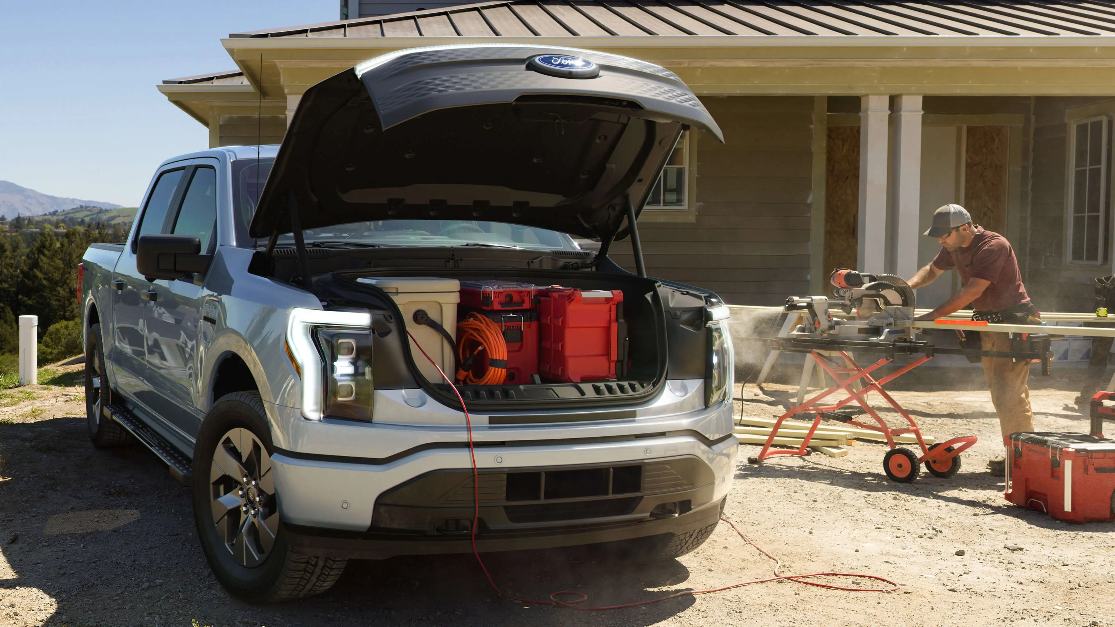 Construction worker powering his equipment with the Ford F150 electric battery