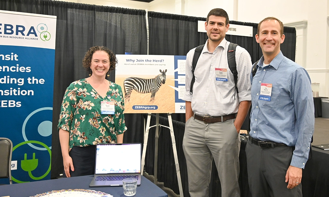 three CTE staff standing in front of ZEBRA booth