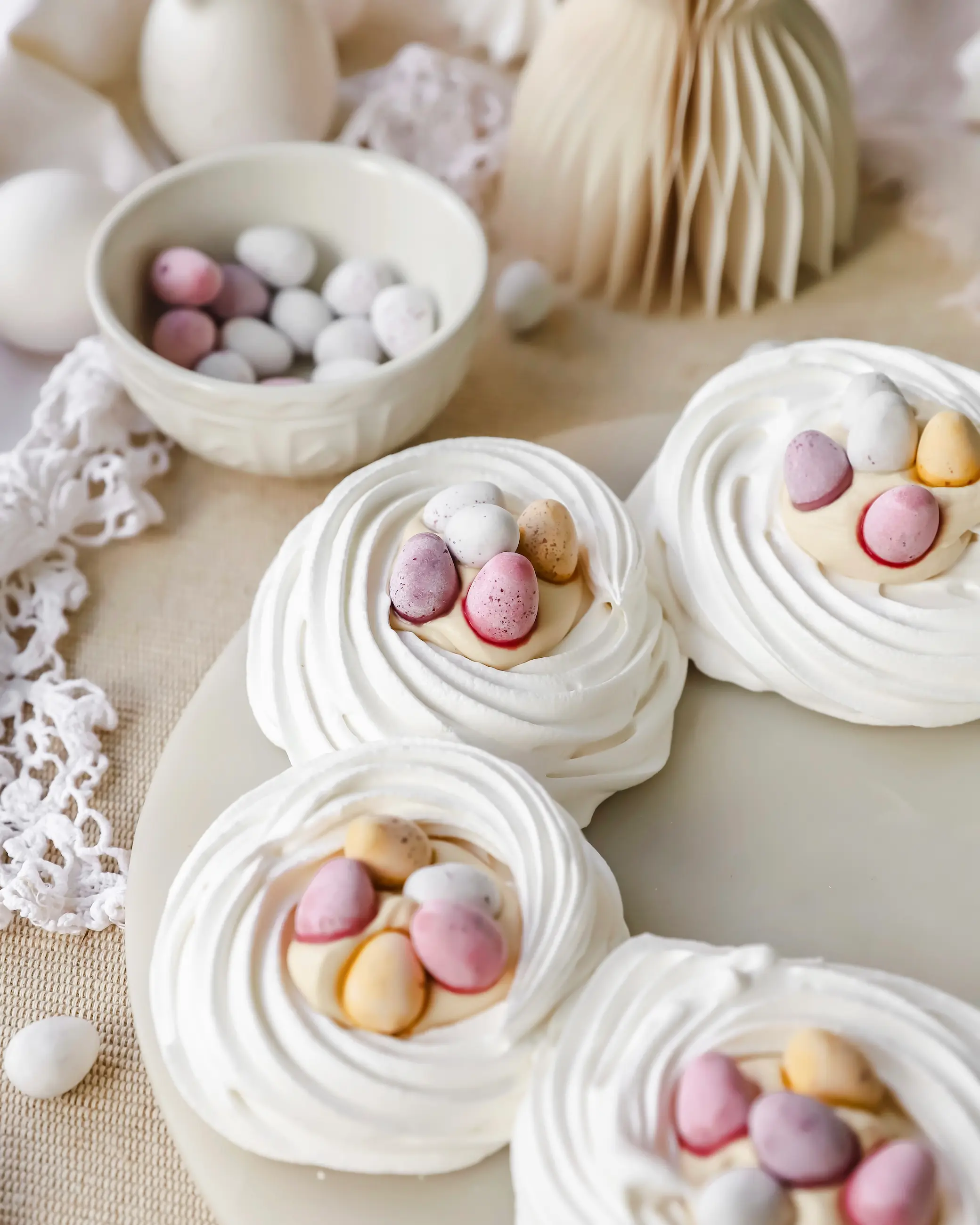 Meringue Wreath nests filled with Biscoff cream and mini eggs. Perfect for an easter table centrepiece