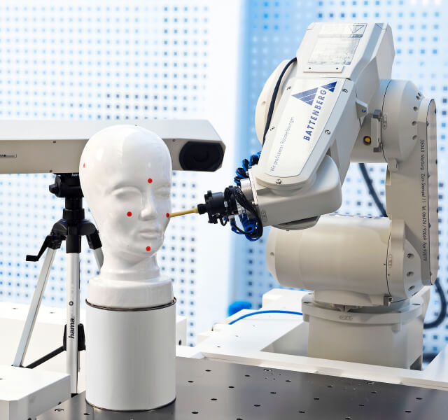 Robot examines the face of a doll