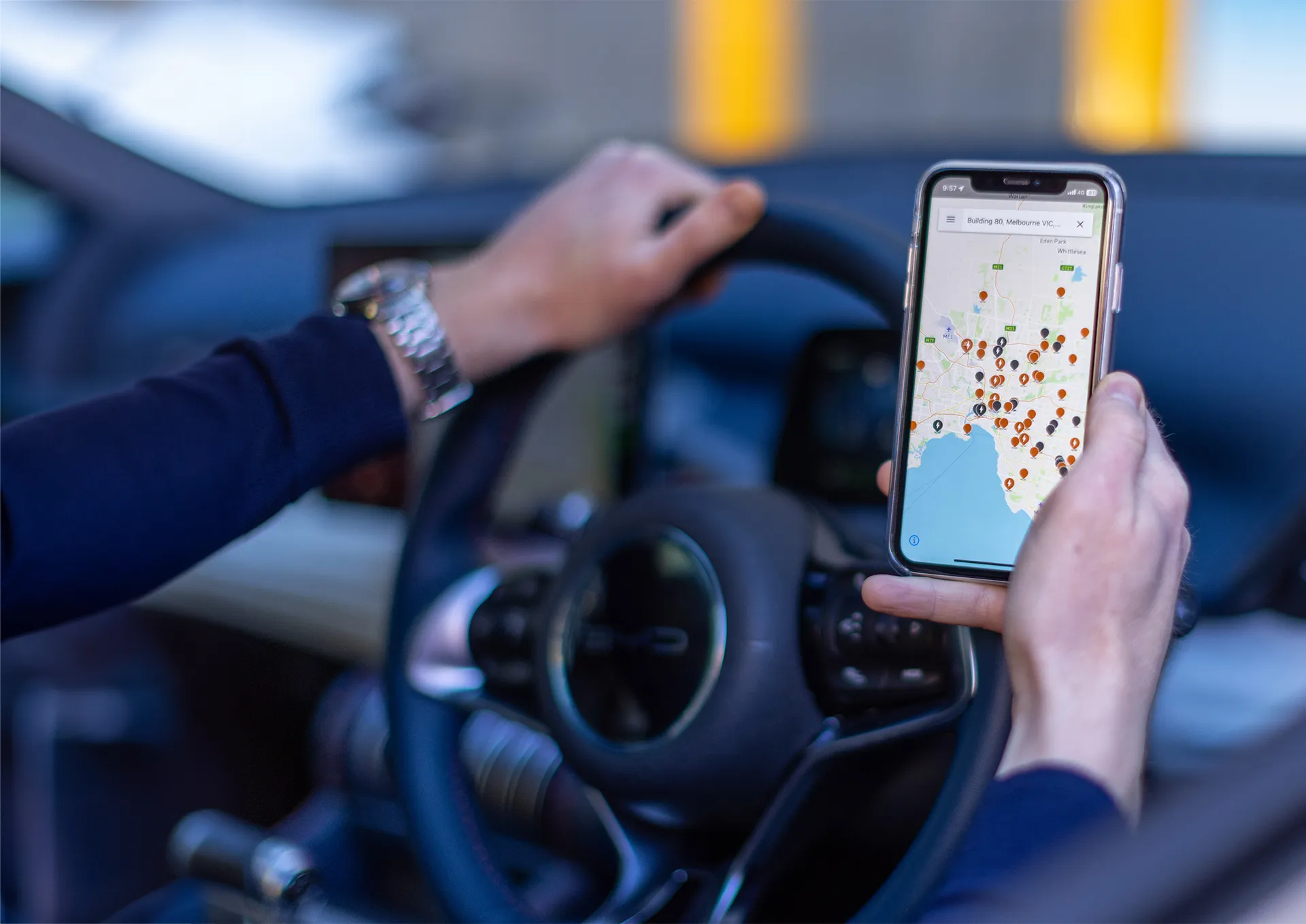 A person using the Chargefox app whilst sitting in their electric vehicle