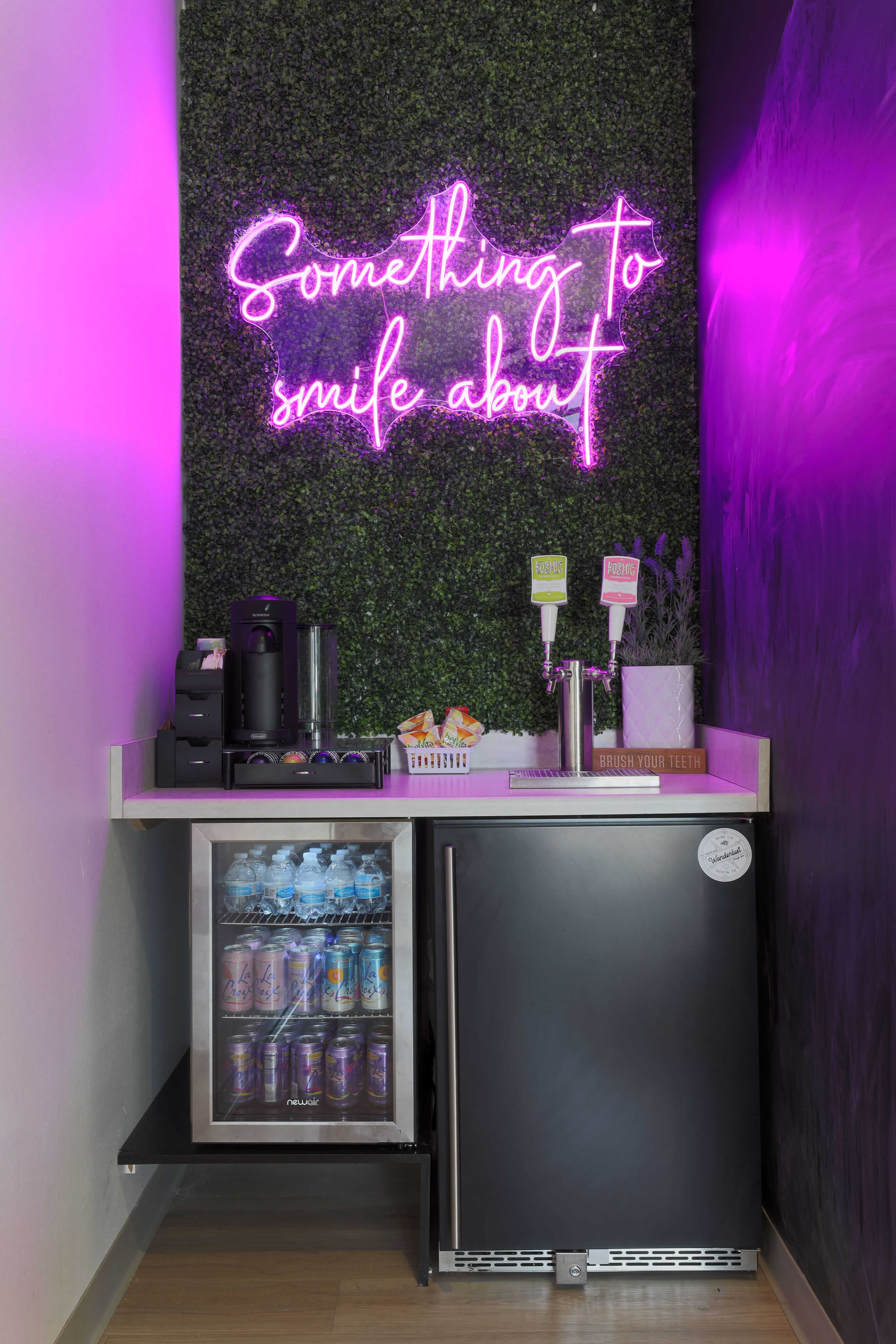 a purple neon sign above a refrigerator in a room