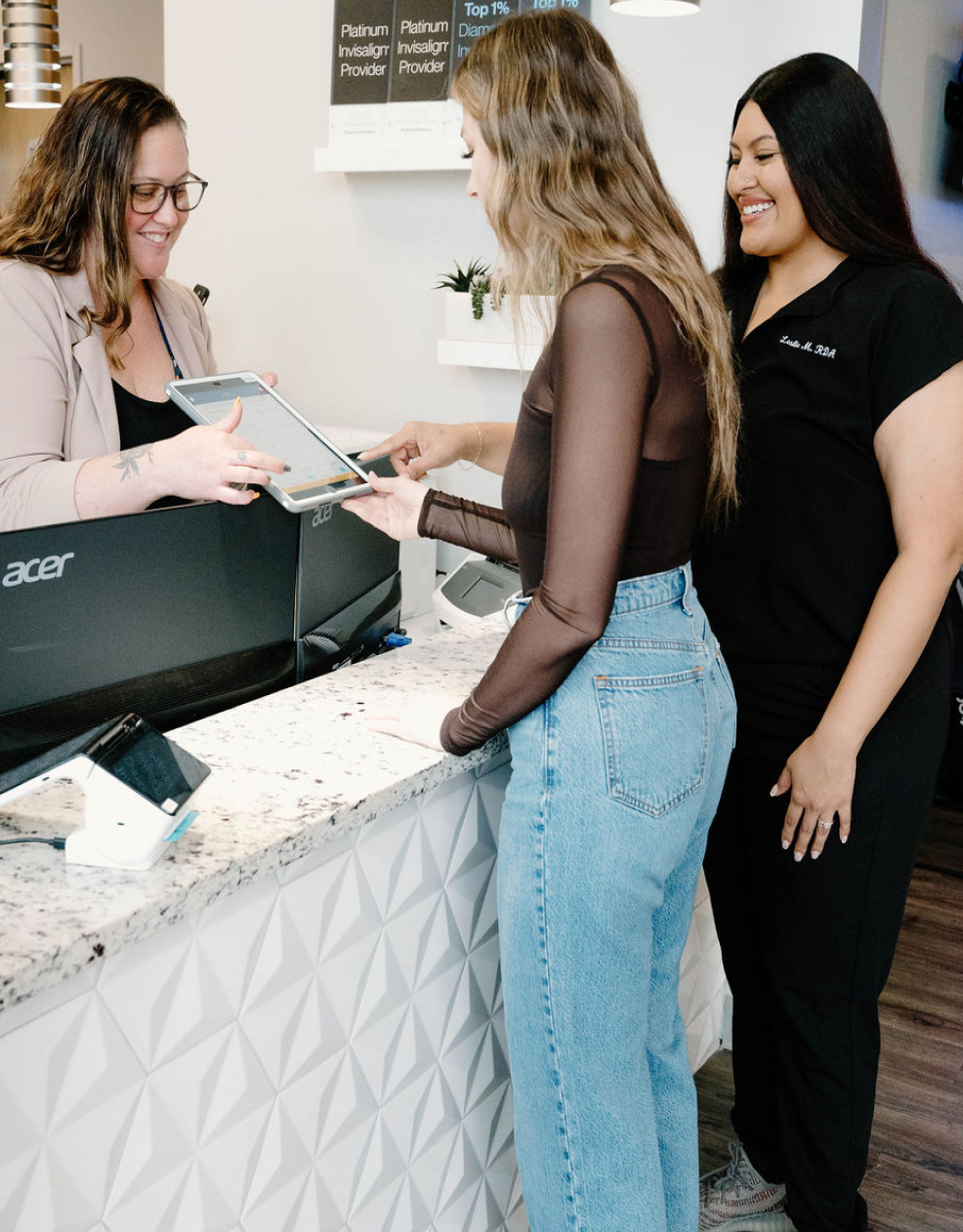 two women standing at a counter in a clinic