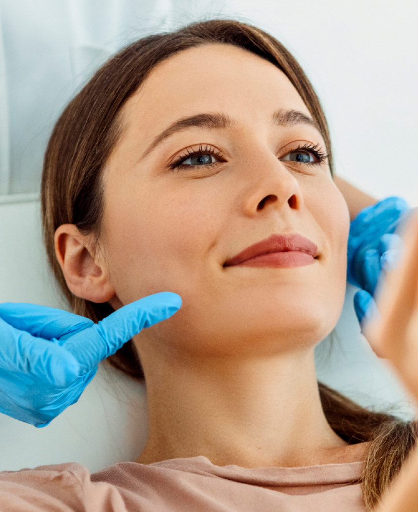 A dermatology patient in a chair receiving care