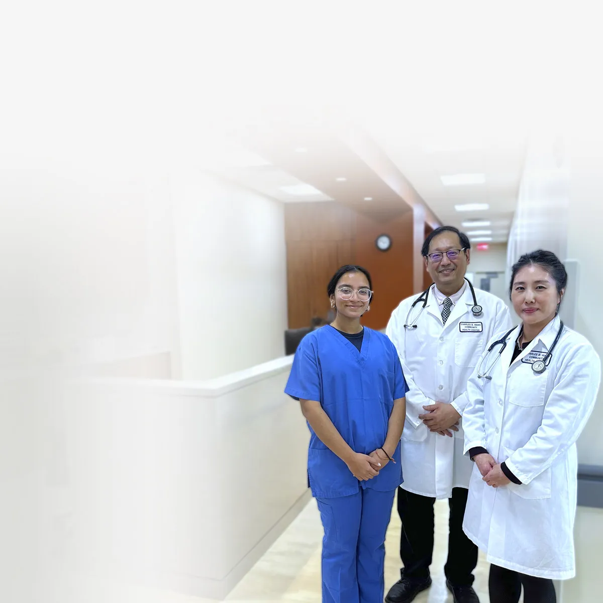 a group of doctors standing next to each other in a doctors office