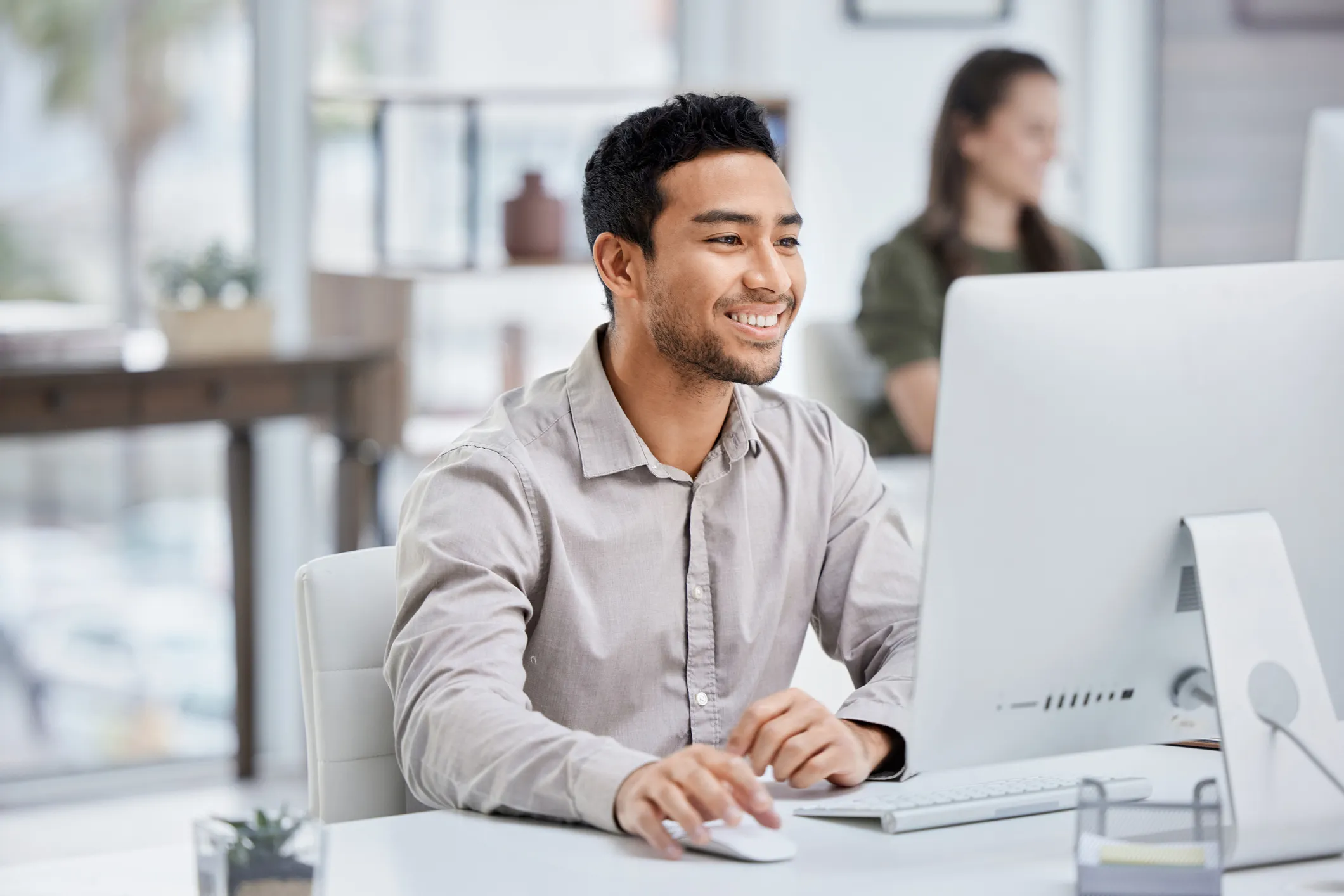 Professional smiling while using a computer