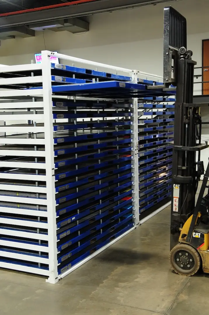 Accessing sheet metal from one of the top shelves with a forklift. 