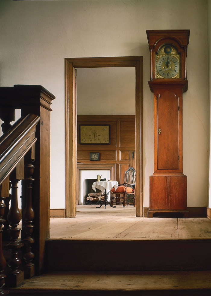 An image of the upstairs hallway, replete with grandfather clock in Wright's Ferry Mansion