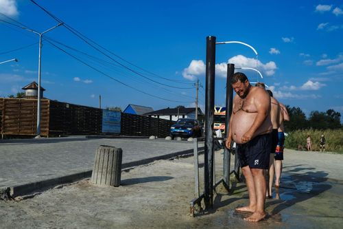 Shower; A Ukrainian soldier taking a shower at Slovyansk Resort. September 3, 2023. Slovyansk Ukraine
