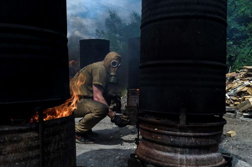 Making camouflage nets; Volunteer in the southern city of Zaporizhzhya, removing colors on camouflage nets using chemicals. May 22, 2023. Zaporizhzhya Ukraine