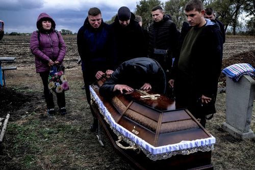 A last farewell; Family says goodbye to 53-year-old Tatyana from Hroza. On 5 October 2023, a missile struck a café in the small village of Hroza in eastern Ukraine, killing 59 people attending a funeral reception. October 9, 2023. Hroza Ukraine