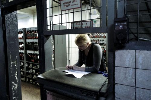 Inside Ukraine’s biggest coal mine; Tanya (48) keeps track of the workers by writing down details about their work-schedules. She is in charge of the headlamps used in the coal mine. November 3, 2023. Donetsk Oblast Ukraine