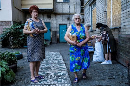 Kherson, after the flooding; 70-year-old Olga (left) and her neighbor, standing in a courtyard surrounded on three sides by old Soviet blocks close to the riverbank in Kherson. Their apartment disappeared after the flooding caused by the destruction of the Nova Kakhovka dam on June 6, 2023. June 22, 2023. Kherson Ukraine