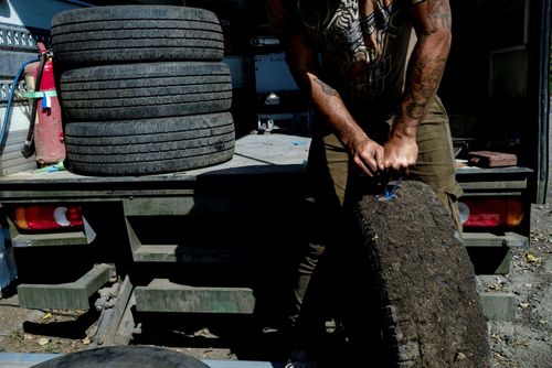Repairing Tires; Kirill (27), fixing tires hit by shrapnel in Slovyansk. September 3, 2023. Slovyansk Ukraine