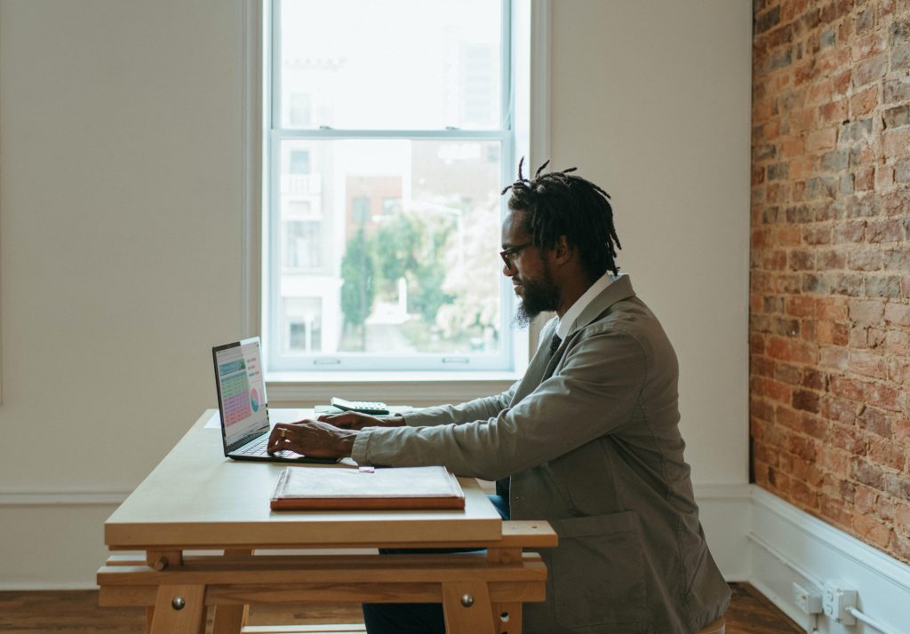 man typing benefits of working remotely