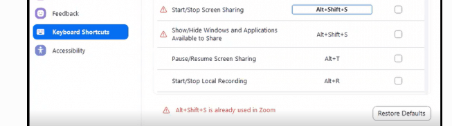 A screenshot of Zoom's preference screen that shows "Keyboard Shortcuts" is selected. To the right is the example of a conflict, where two commands have the same shortcut.