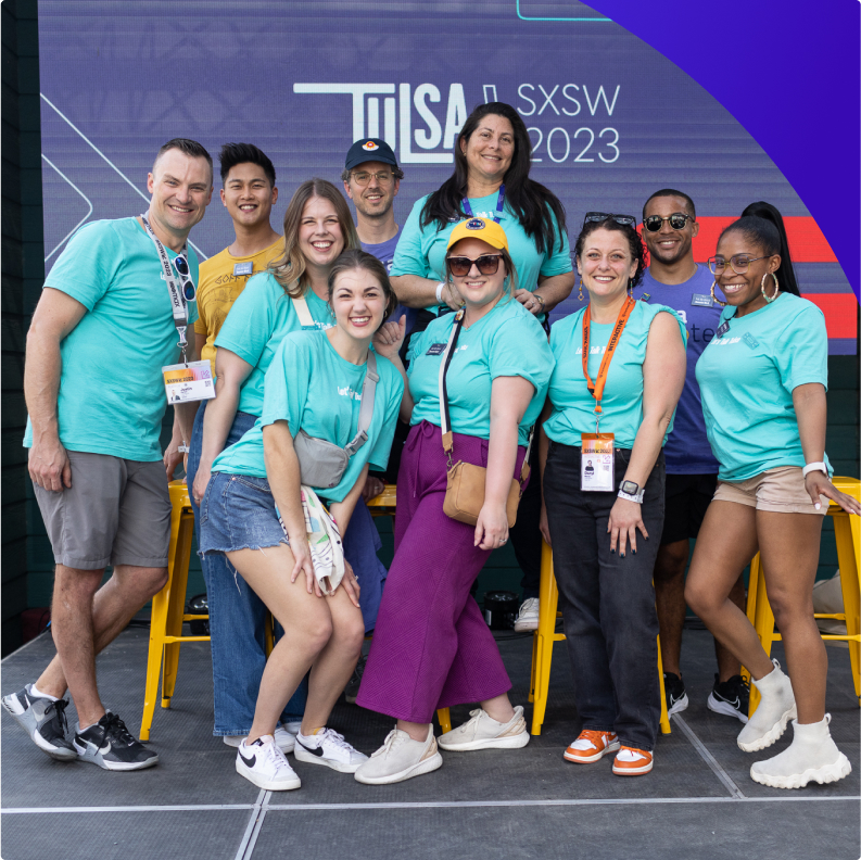 Tulsa remote team standing on a stage at SxSW