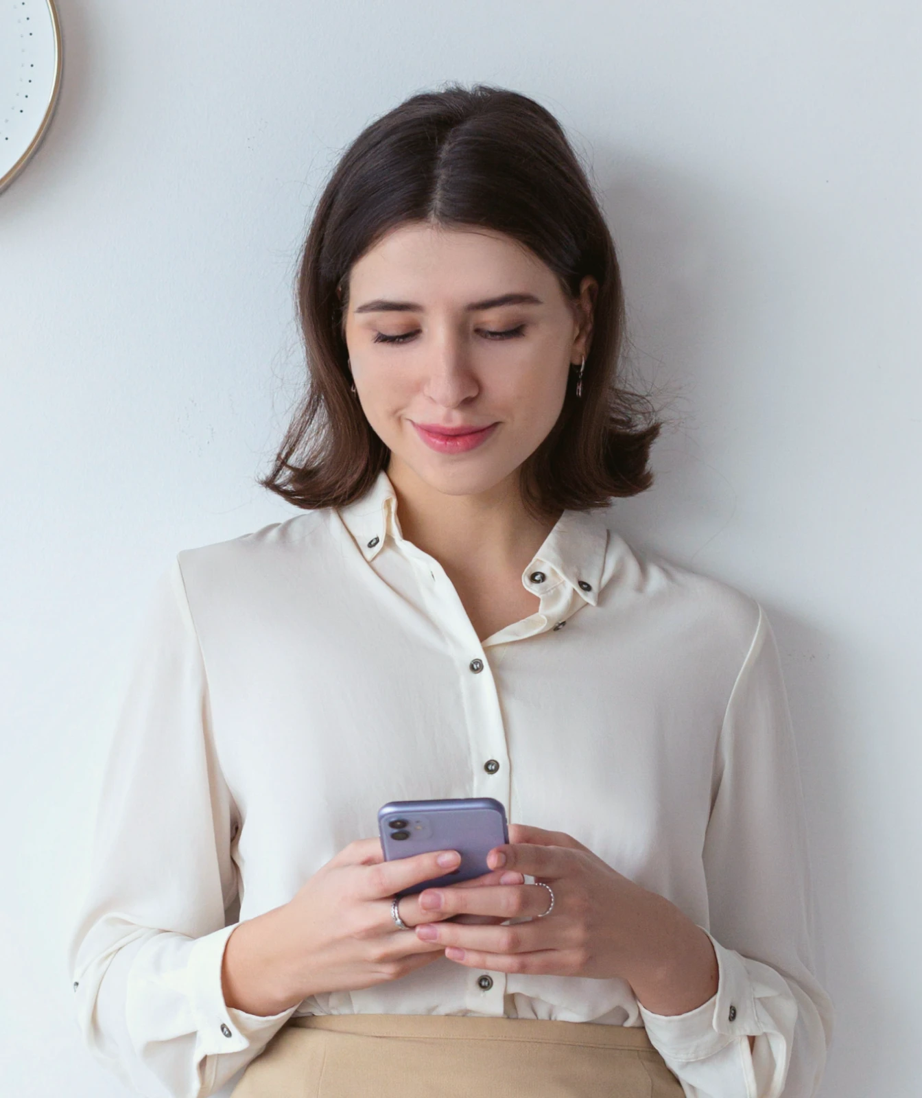 Woman holding her cell phone in her hand