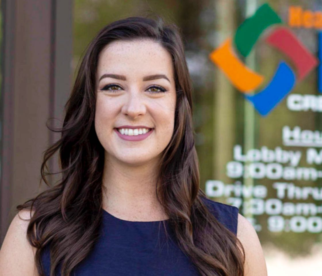 woman customer smiling outside of Healthcare Plus Federal Credit