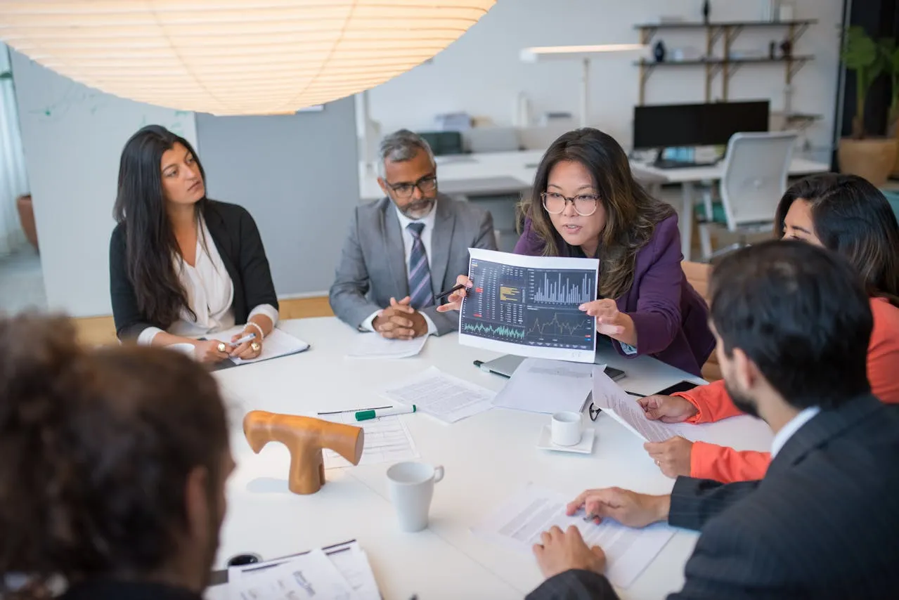 A group of people sitting around a table.