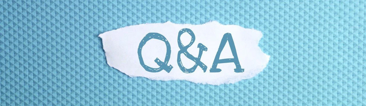 a torn paper written with inscription Q & A